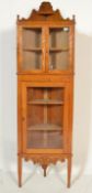 A 20th century Chestnut corner display cabinet, the upper section having twin glazed doors with