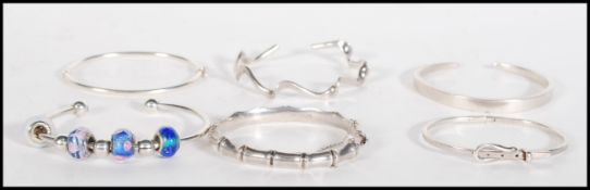 A selection of stamped 925 silver bangle bracelets ro include a a bamboo bangle with a hinge