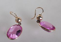 A pair of stamped 375 9ct gold ladies drop earrings set with large oval cut pink synthetic