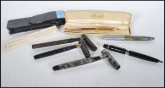 A collection of vintage writing pens to include a Parker fountain pen with a 14k gold nib, a