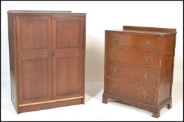 A 1940's oak four drawer chest of drawers raised on bracket feet with drop swing handles. Together