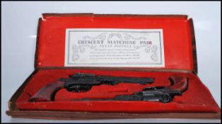 A vintage matching pair of Crescent Toys replica Texan Pistols finished in black having foliate