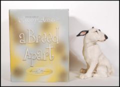 A large composite figurine modelled as an English Bull Terrier in the sat position upon a