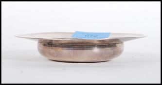 A silver hallmarked ashtray of round form with a flared rim. Hallmarked London (date mark rubbed).