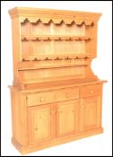 An antique style large country pine welsh dresser. The base with a series of drawers and cupboards