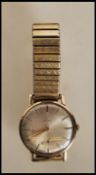 A vintage mid 20th Century Cyma 9ct gold case wrist watch having a round face with a silvered