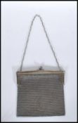 A 20th Century vintage silver mesh purse / bag having ball clasp to the top on a chain strap.