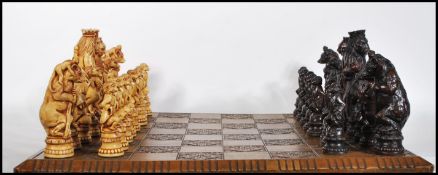 A 20th Century chess set having stylised resin animal kingdom character pieces, with the King and