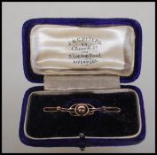 A Victorian 9ct gold brooch with wire work roundles and central ball finial flanked by two smaller