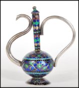 A 20th Century silver ornamental Cloisonne teapot raised on a round foot with a bulbous body and