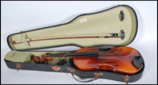 A 20th Century Violin musical instrument having a one piece maple back with spruce front. Ebonised