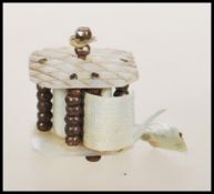 A 19th Century Georgian tape measure of small proportions constructed from two mother of pearl