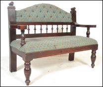 A 20th Century Victorian style /  gothic revival oak framed hall settle, button back embroidered