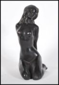 A 20th Century bronze sculpture of a reclining nude lady. Measures 19cm tall.
