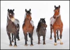 A collection of four Beswick ceramic figurines modelled as horses to include a Shetland pony, a