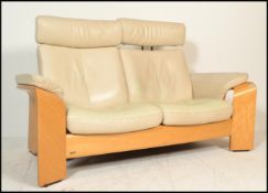 A stunning Ekornes Stressless two seater plus system reclining leather sofa, upholstered in white
