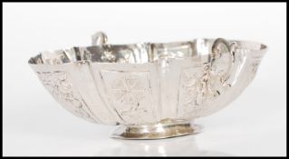 A 19th Century continental silver bonbon dish of oval form with twin handles. The body having floral