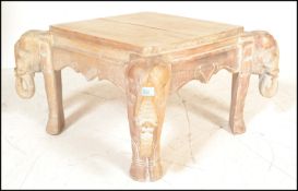 An antique style hardwood African occasional / coffee table. Each leg being carved in the form of an