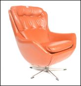An original 1960's retro vintage red button back swivel egg type chair / armchair being raised on