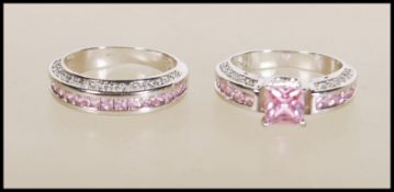 A pair of 9ct white gold filled rings to include one band ring set with three rows of pink and white