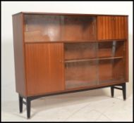 A vintage mid 20th Century teak wood sideboard credenza by Nathan having a configuration of glazed