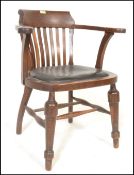 An early 20th Century Edwardian oak office elbow chair / armchair with slatted back and leather