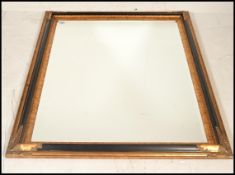 A large 20th century Antique revival French wall mirror of cushion form with ebonised ground and