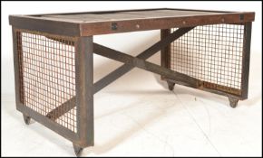 A stunning vintage 20th Century industrial factory trolley having a planked wooden top raised on a