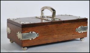 An Edwardian early 20th Century oak two section humidor having two hinged lids opening to reveal