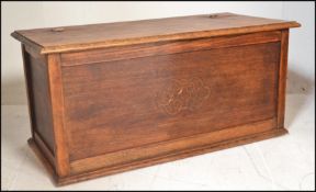 A 20th Century oak panelled coffer / blanket box chest, hinged panelled top raised on a plinth