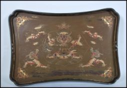 An early / mid 20th Century Chinese lacquer tray decorated with five toed Chinese dragons and floral