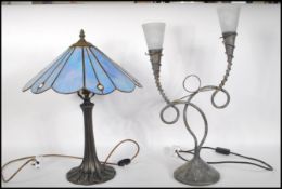 An antique style Tiffany type table lamp with naturalistic column base having stained and leaded