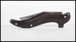 A 19th Century novelty folding pocket / pen knife in the form of a heeled shoe. Blade marked Encore.