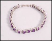 A stamped 925 silver bracelet set with oval cut amethysts and round cut CZ's. Weight 22.1g. Measures