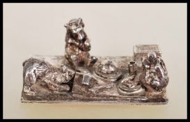 A silver hallmarked Thomas Charles Jarvis ornament depicting three bears having a picnic. Hallmarked