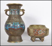 A 20th Century Chinese brass oriental vase of bulbous form having twin handle atop with enamel