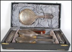 A silver hallmarked Edwardian traveling vanity six piece dressing table set, dating to 1917,