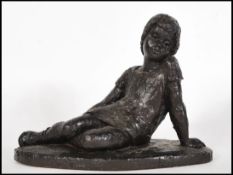 Karin Jonzen (1914-1998), bronzed resin sculpture of a girl reclining. Signed with initials KJ to
