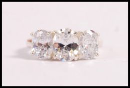 A stamped 925 silver dress ring set with three oval cut CZ's. Total weight 5.1g. Size P.