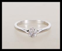 A stamped 18ct white gold solitaire ring set with a brilliant cut diamond. Weight 2.5g. Size J.