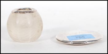 A silver hallmarked compact of round form having engine turned decoration with mirror to the