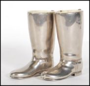 A pair of 20th Century silver plated drinks measures in the form of riding boots having raised