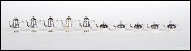 An unusual set of 10 20th century silver plate menu holders all in the form of teapots and coffee