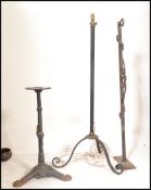 A collection of vintage metal stands to include a vintage cast metal bubble gum stand, an iron pub