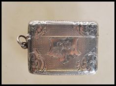 A 19th Century Victorian silver hallmarked vesta case having engine turned and floral engraved