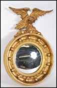 A 19th century gilt wood and gesso convex porthole mirror applied with eagle atop. The circular
