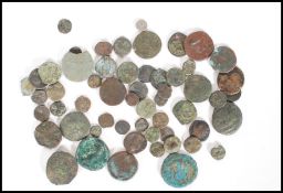 A collection of ancient bronze coins to include a Byzantine Justinian I coin, a possibly Sicilian