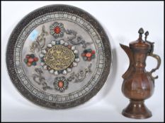 An early 20th Century copper hand worked Persian style coffee pot together with a large wall charger