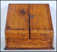 An early 20th Century light oak stationary desk tidy with double doors revealing compartmental