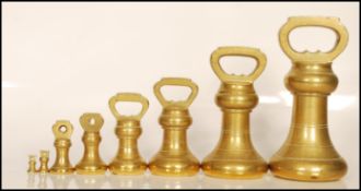 A set of eight 19th / 20th Century graduating brass bell weights, the largest weighing 7lb all the